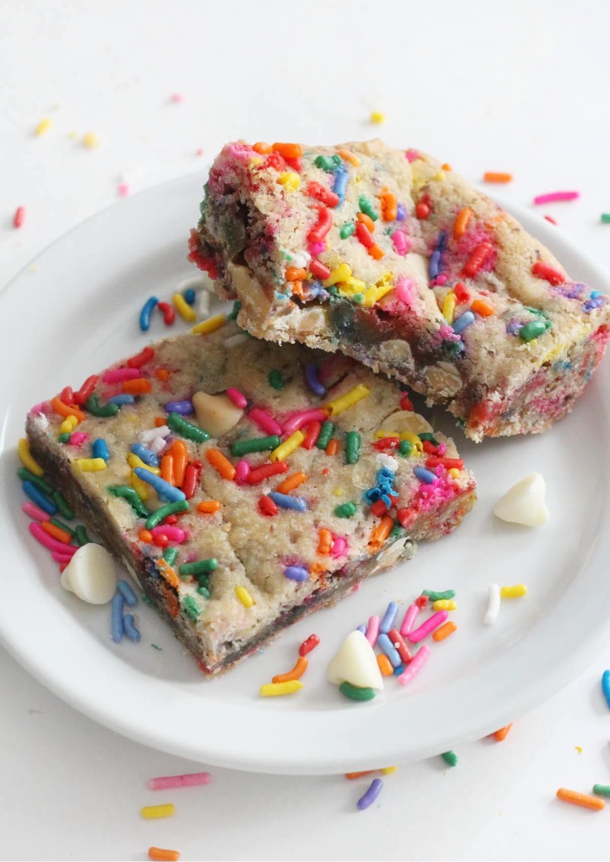 gluten-free funfetti blondies on a white plate with sprinkles