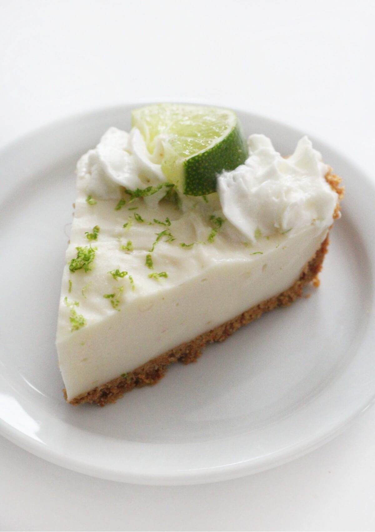 single slice of vegan key lime pie on white plate