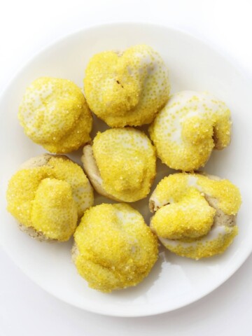 overhead view of full plate of glazed gluten-free Italian lemon knot cookies