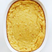 overhead view of baked vegan corn casserole in oval casserole dish
