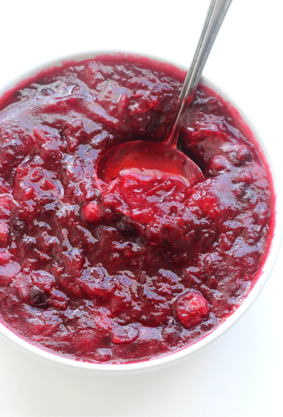 whole berry cranberry sauce in bowl with ladle close up