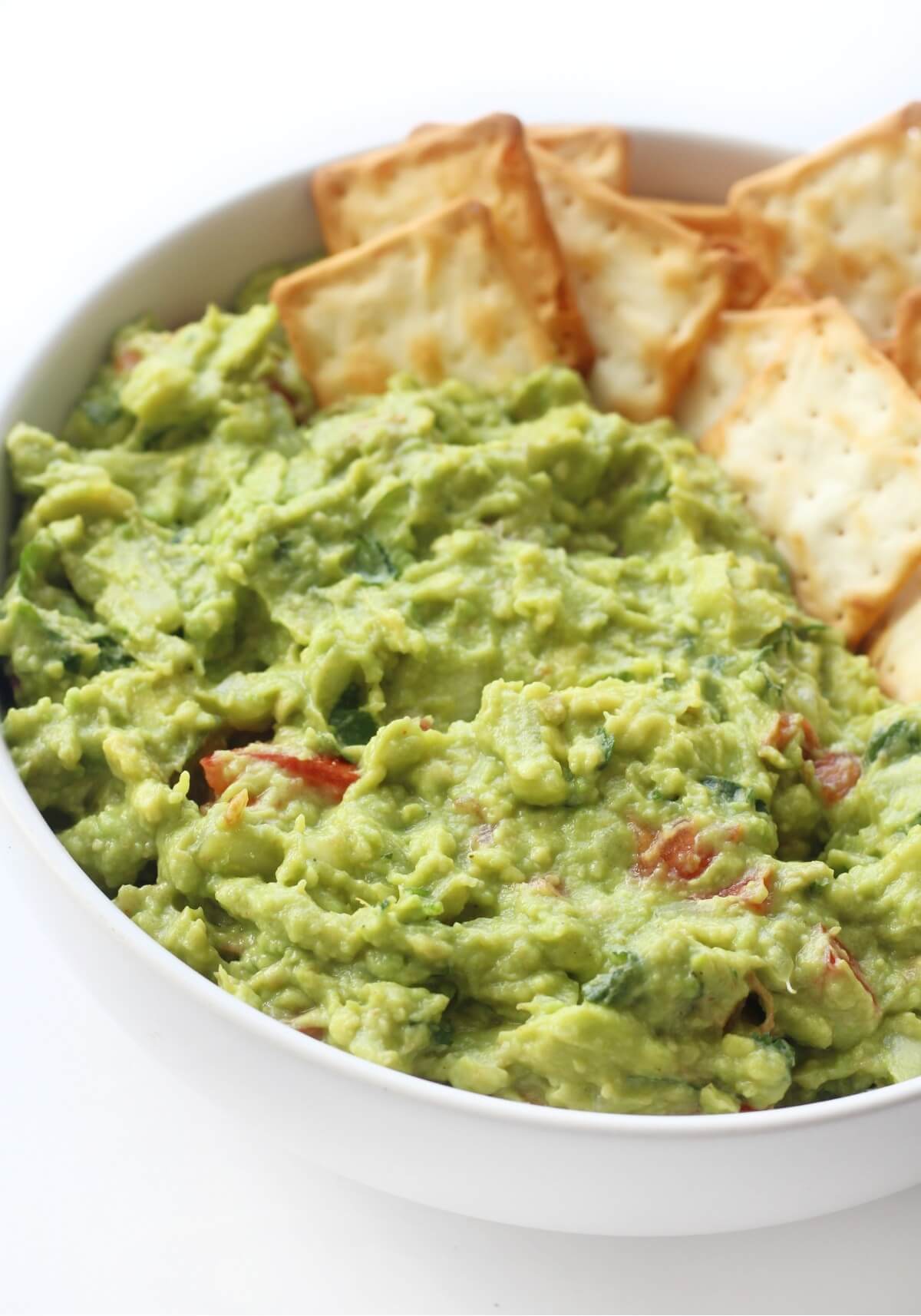close up of fresh authentic guacamole in bowl