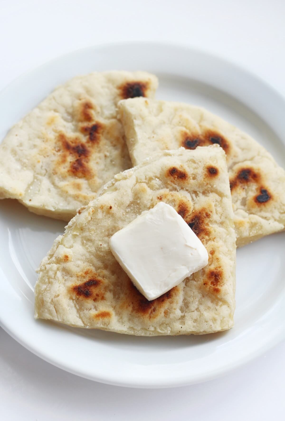 Irish potato bread farls on white plate with butter.