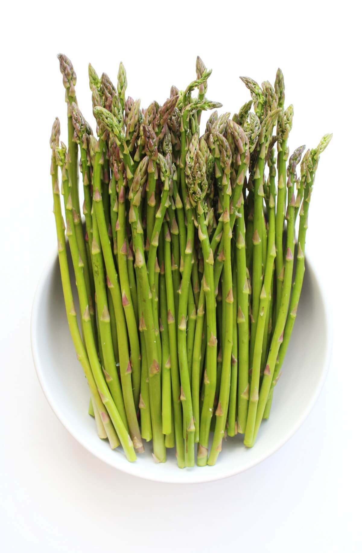 raw asparagus spears in bowl