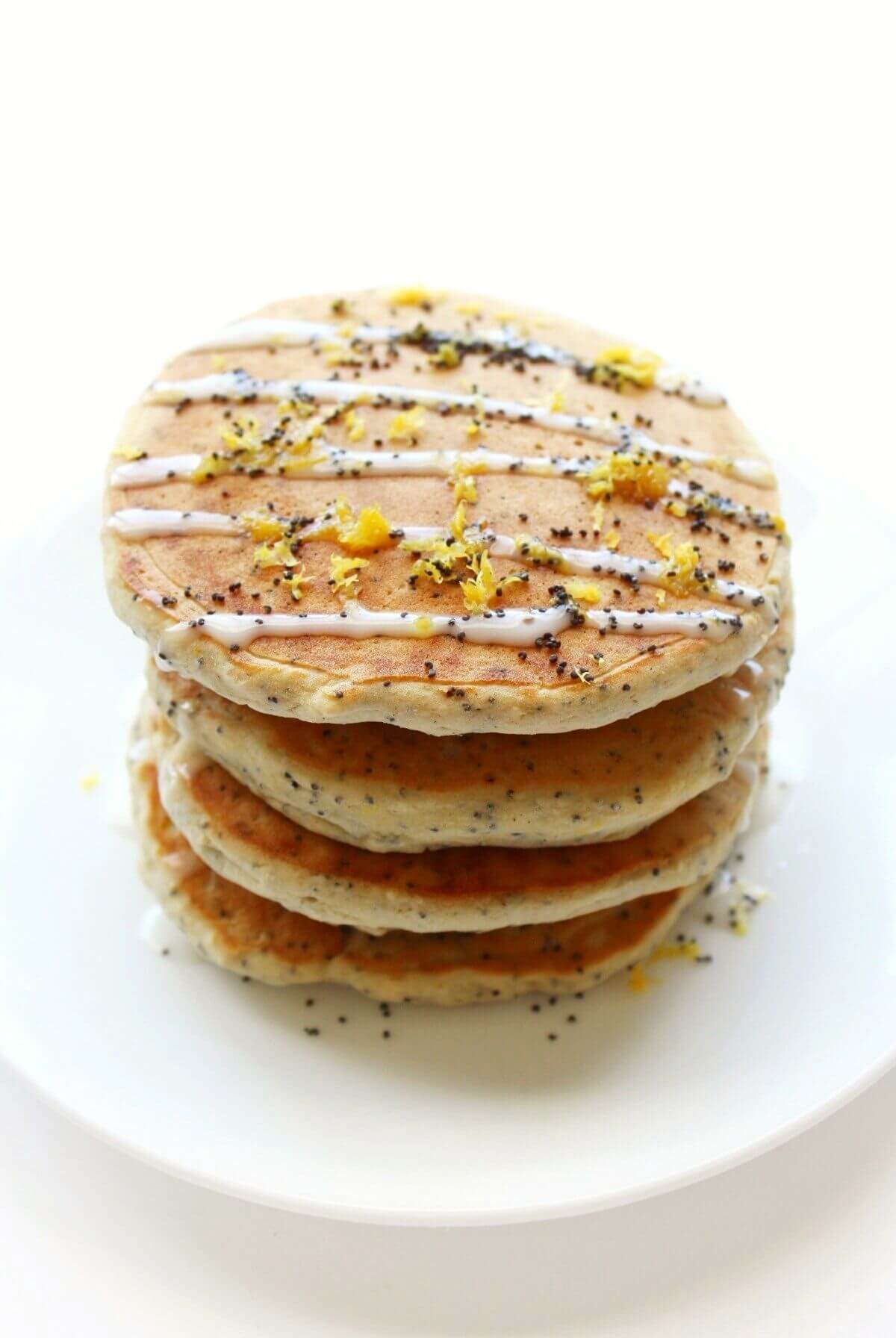 full standing stack of vegan lemon poppy seed pancakes on plate