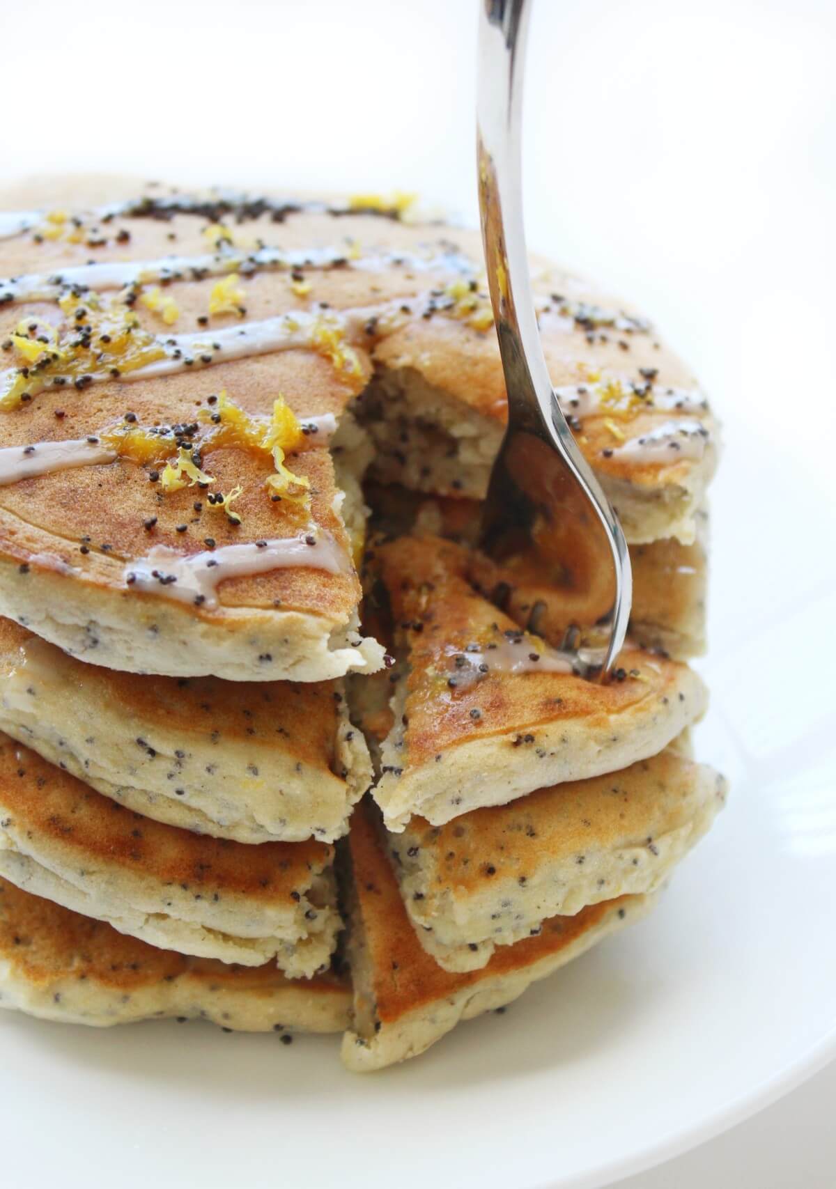 stack of vegan gluten-free lemon poppy seed pancakes with forkful