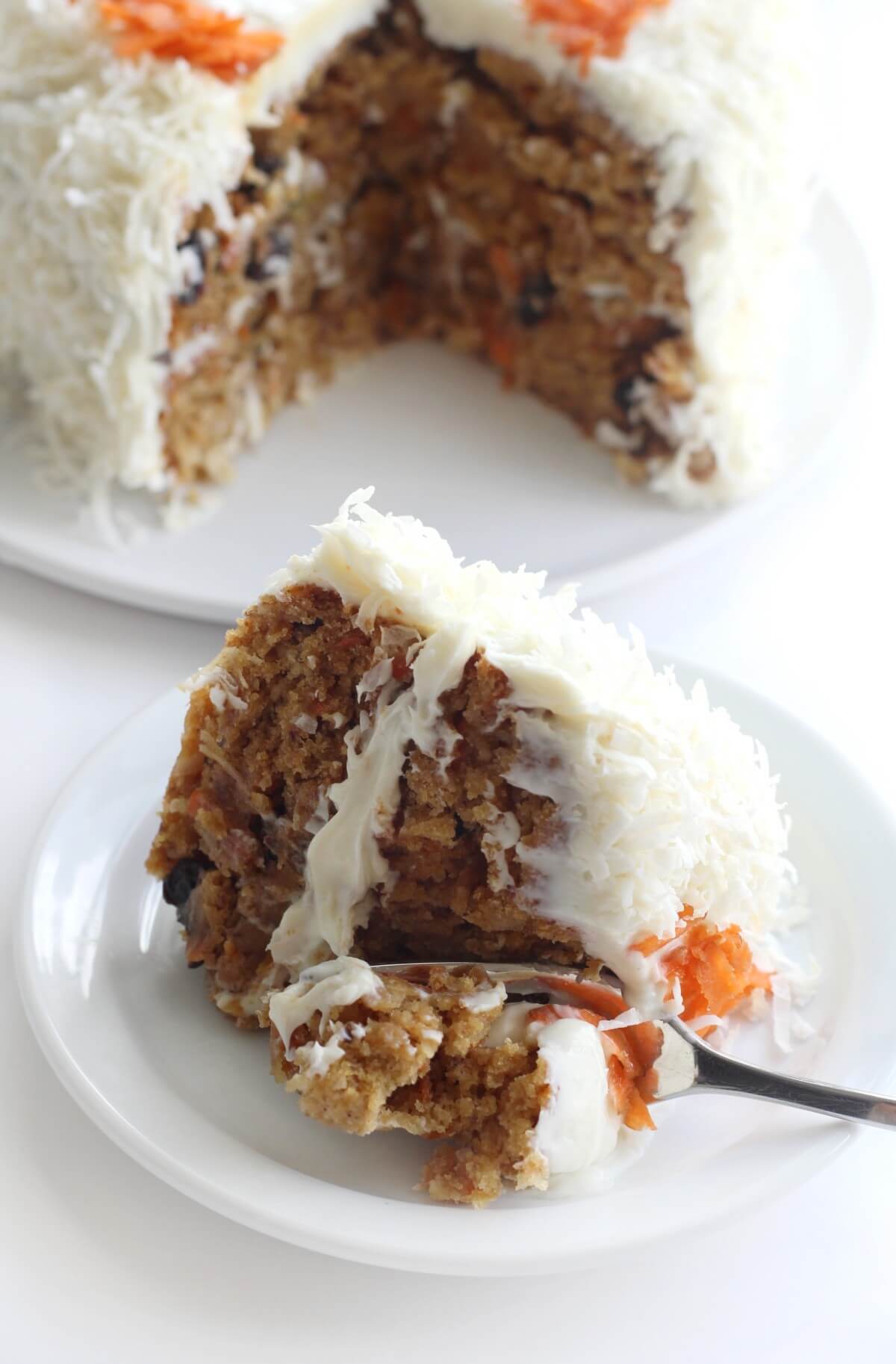 gluten-free vegan carrot cake with slice cut on plate with fork