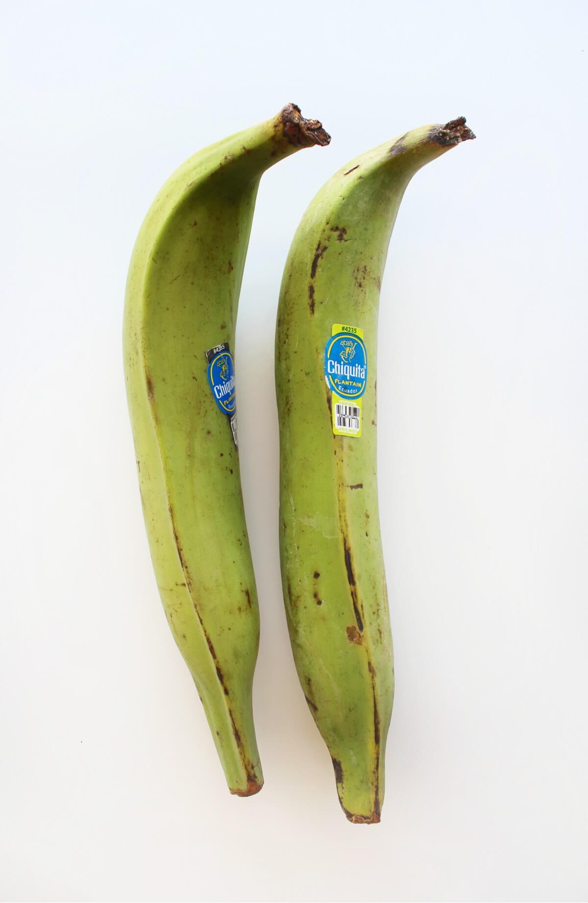 two unpeeled green plantains