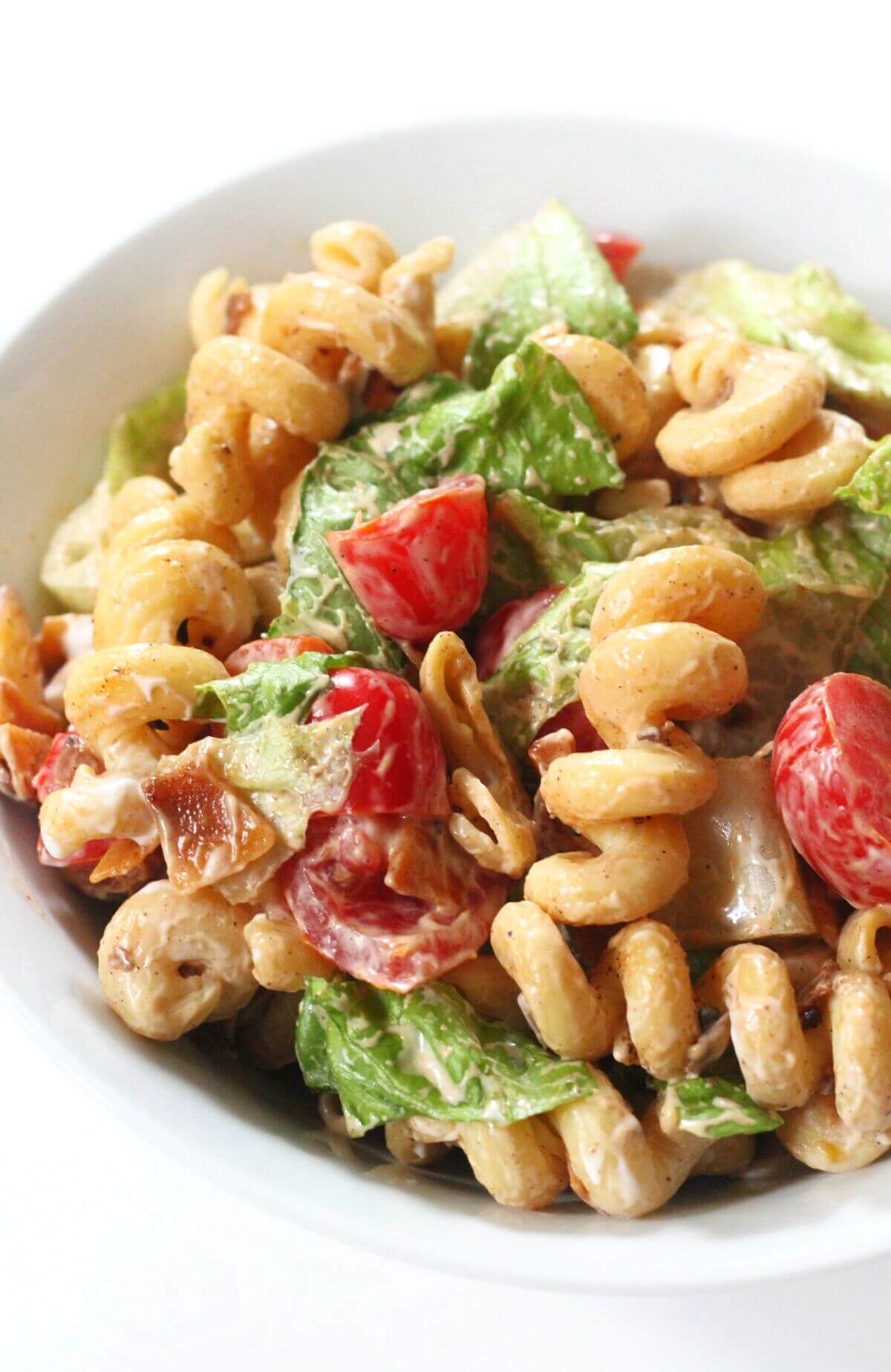 close up of serving bowl with vegan blt pasta salad