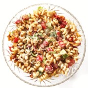 overhead view of vegan blt pasta salad in glass bowl