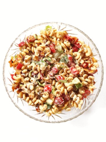 overhead view of vegan blt pasta salad in glass bowl