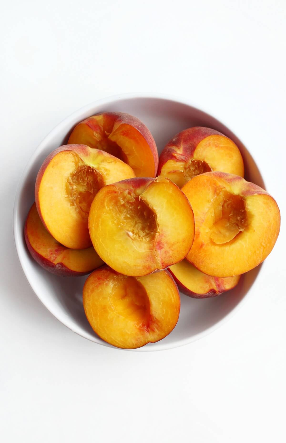 bowl of halved and pitted peaches