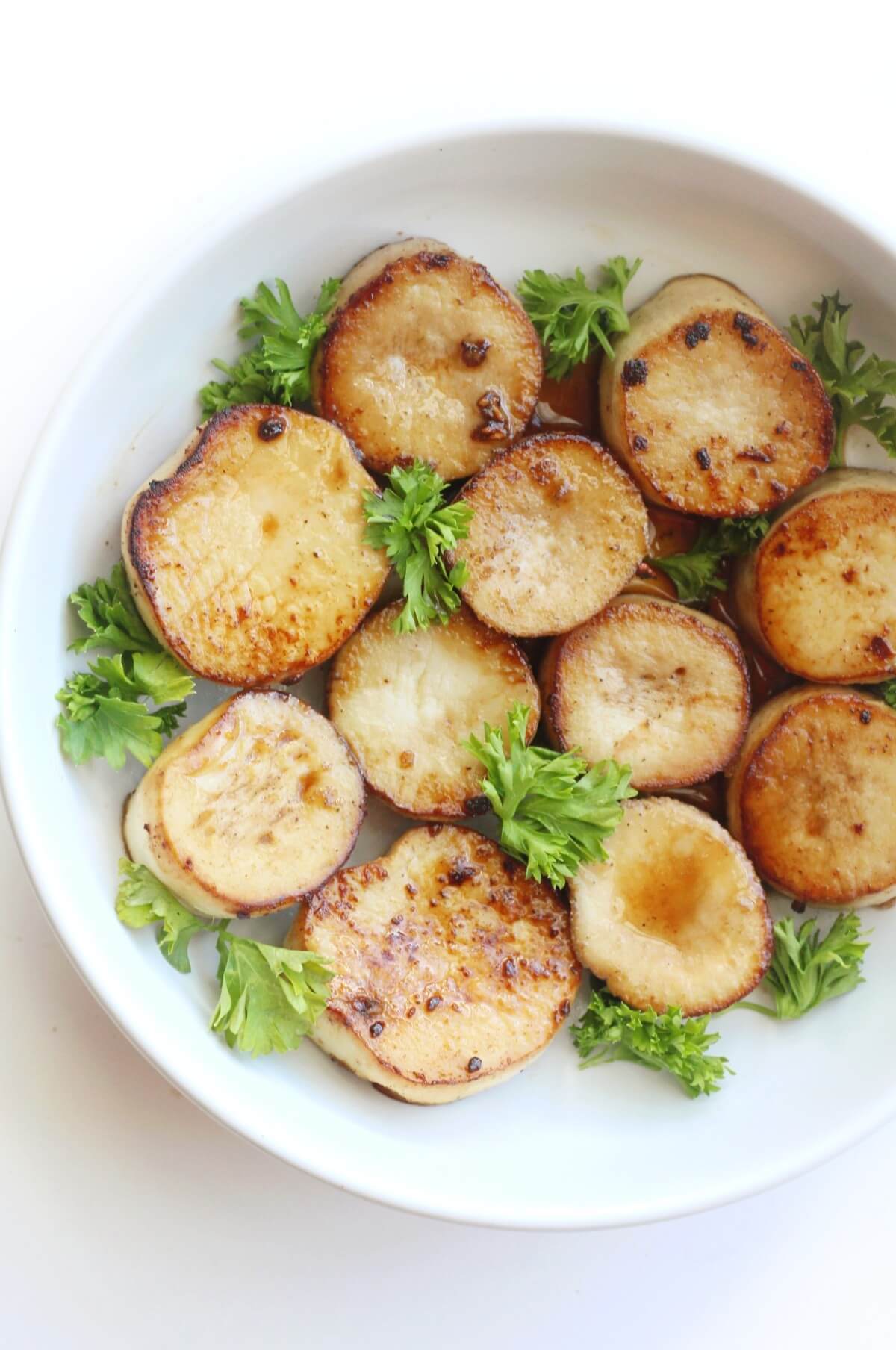 close up of vegan scallops in serving bowl with parsley