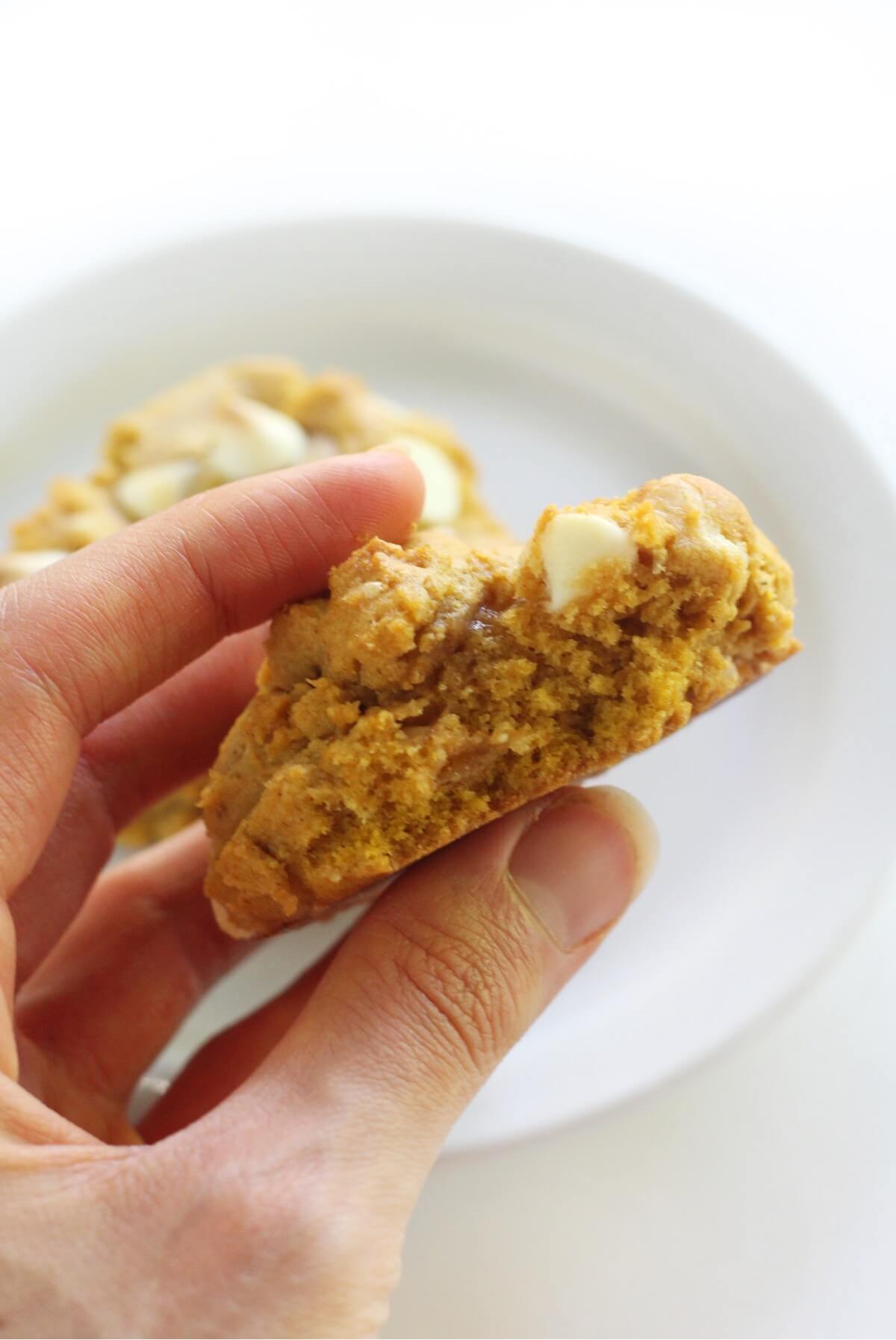 inside look at bitten into pumpkin white chocolate chip cookie
