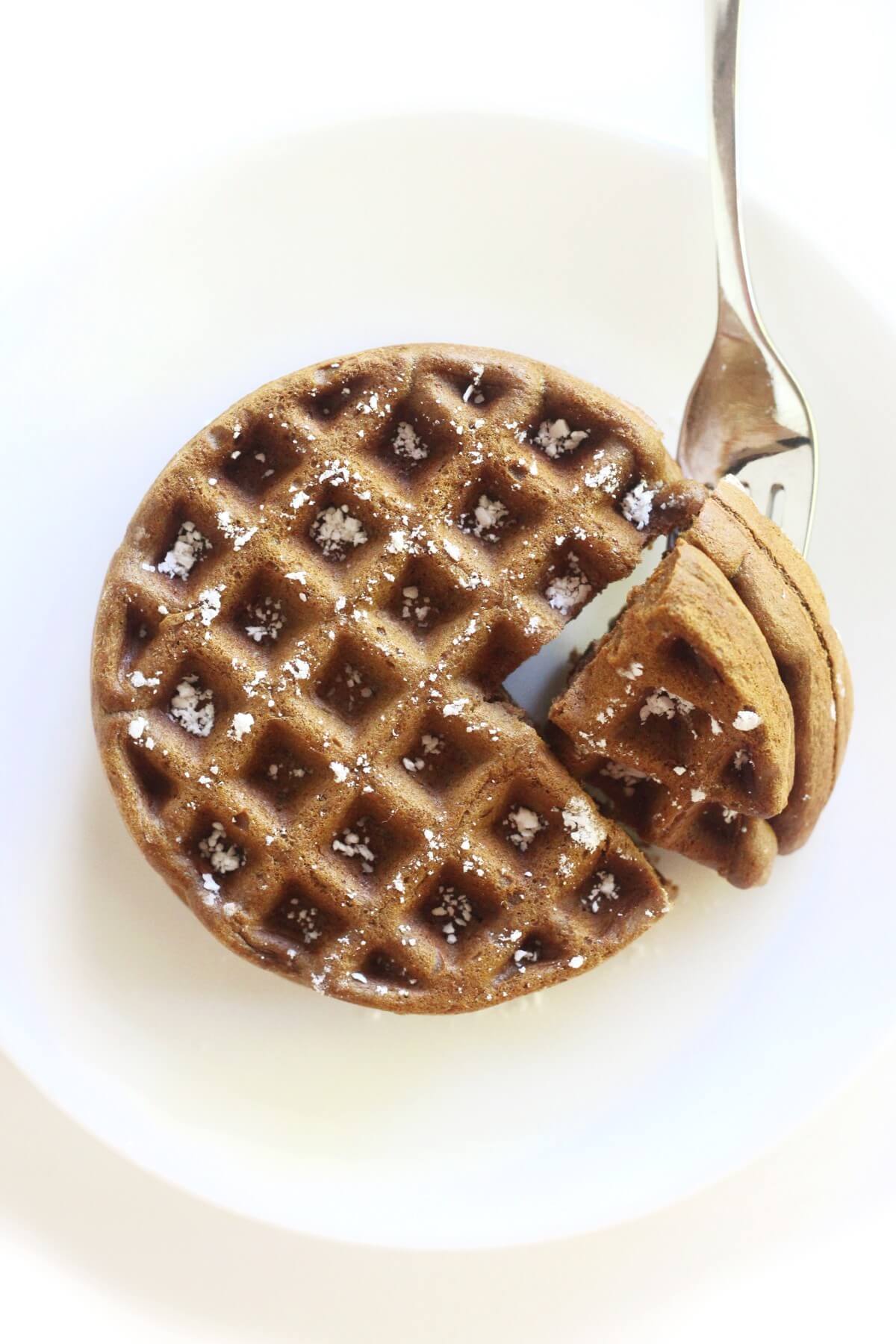 overhead view of gluten-free gingerbread waffles with fork bite