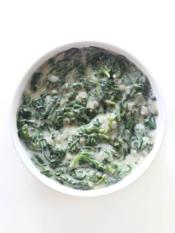 overhead view of vegan creamed spinach in serving bowl