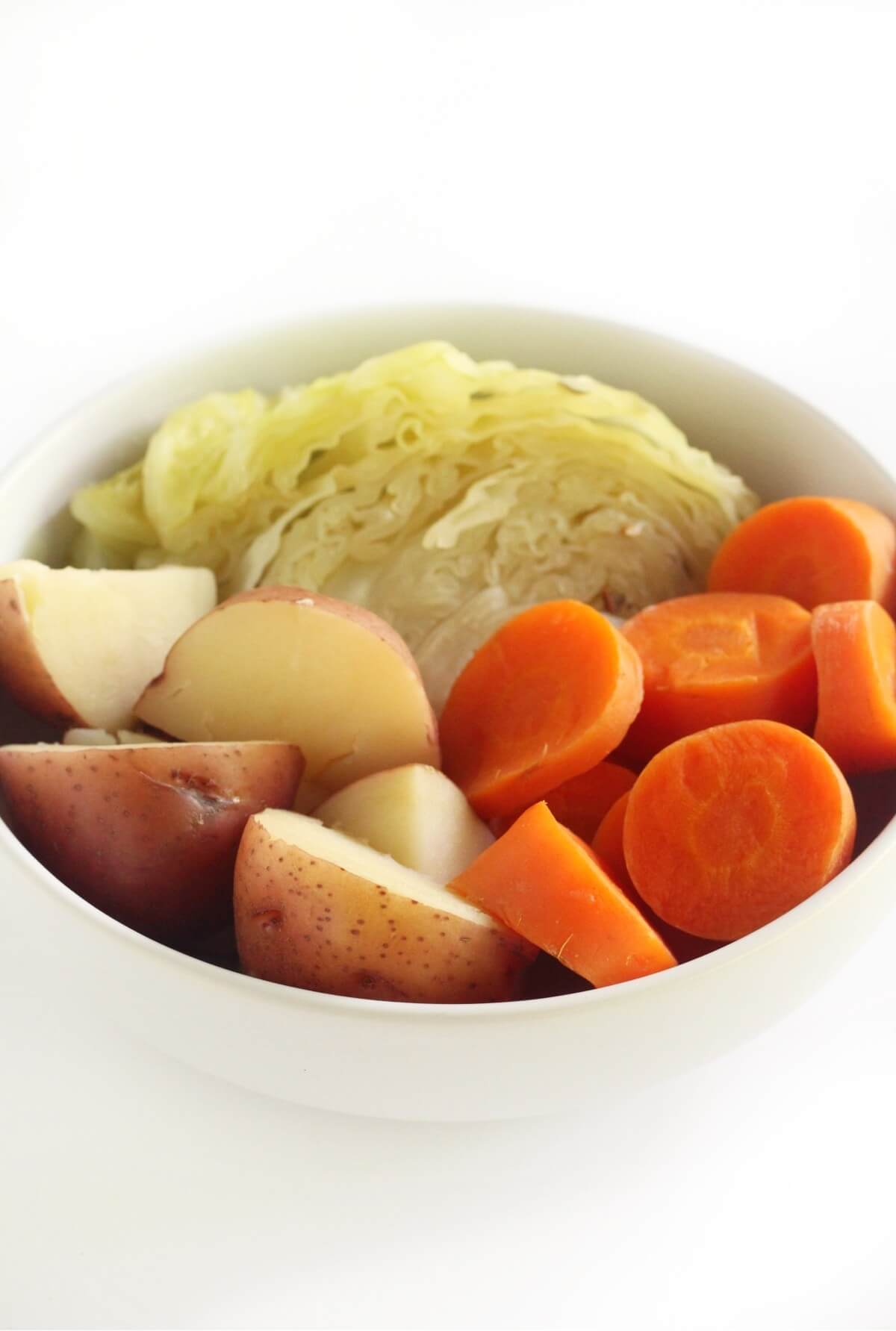 eye-level view of vegan boiled dinner vegetables in serving bowl