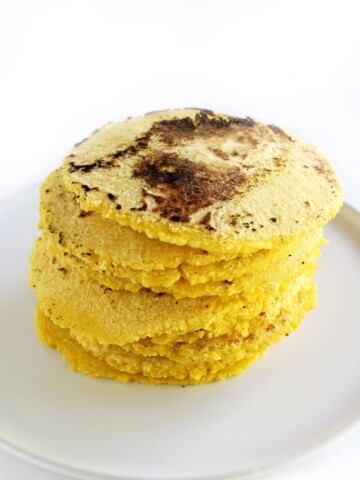 finished stack of homemade gluten-free corn tortillas on plate