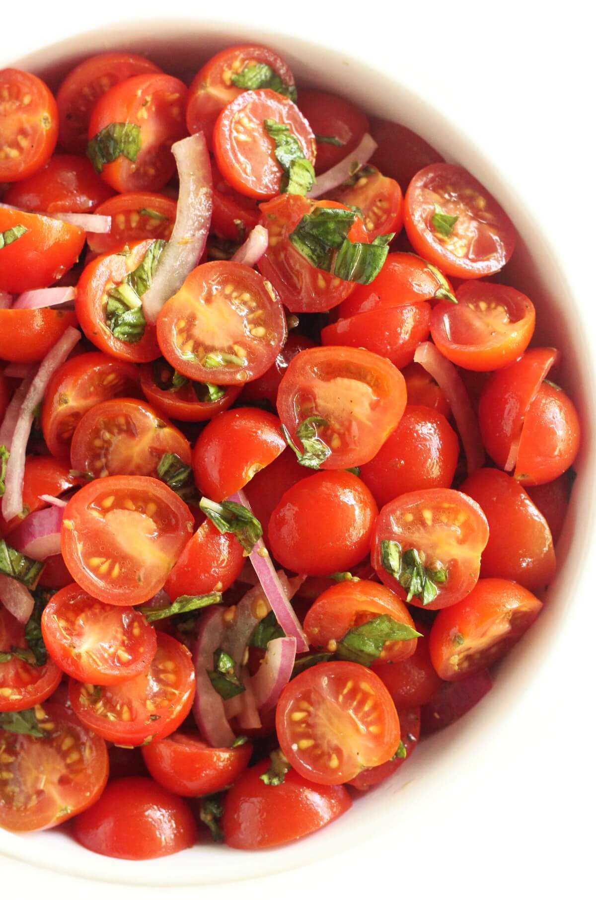 close up of right side of cherry tomato salad in bowl