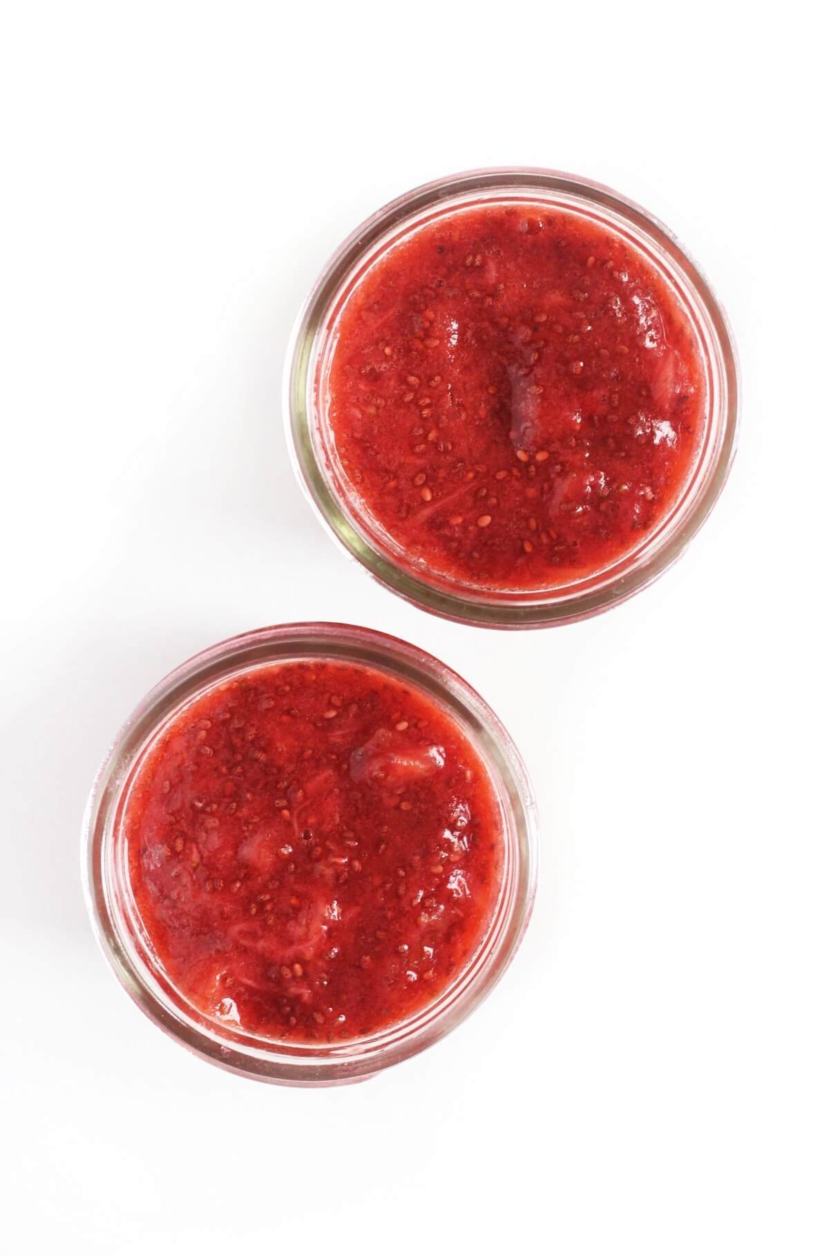 two jars of easy strawberry chia seed jam overhead view