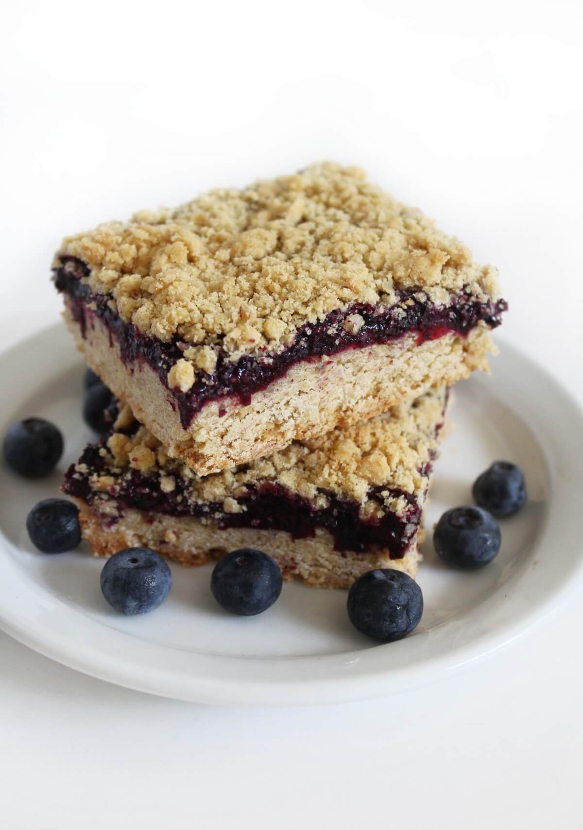close up of two stacked vegan blueberry crumb bars