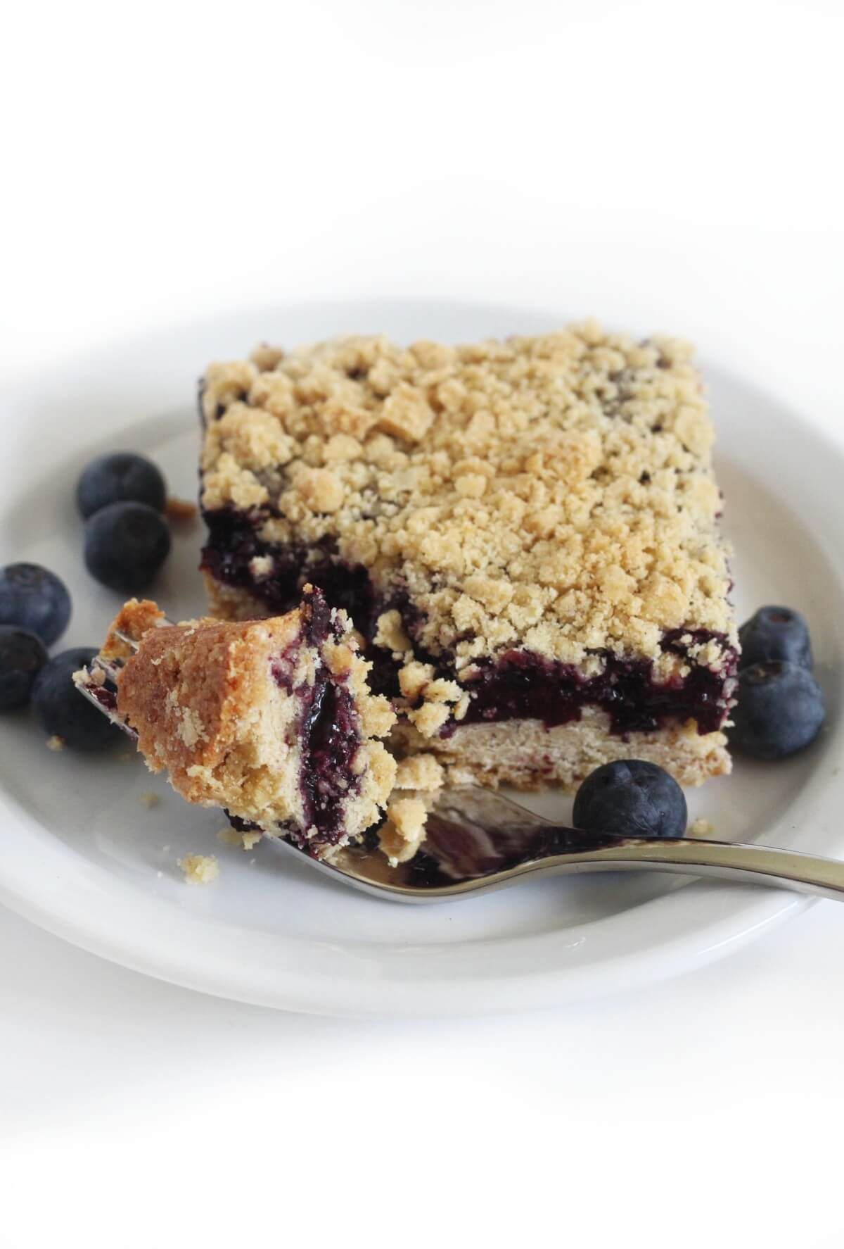 close up of forkful of gluten-free vegan blueberry crumb bar