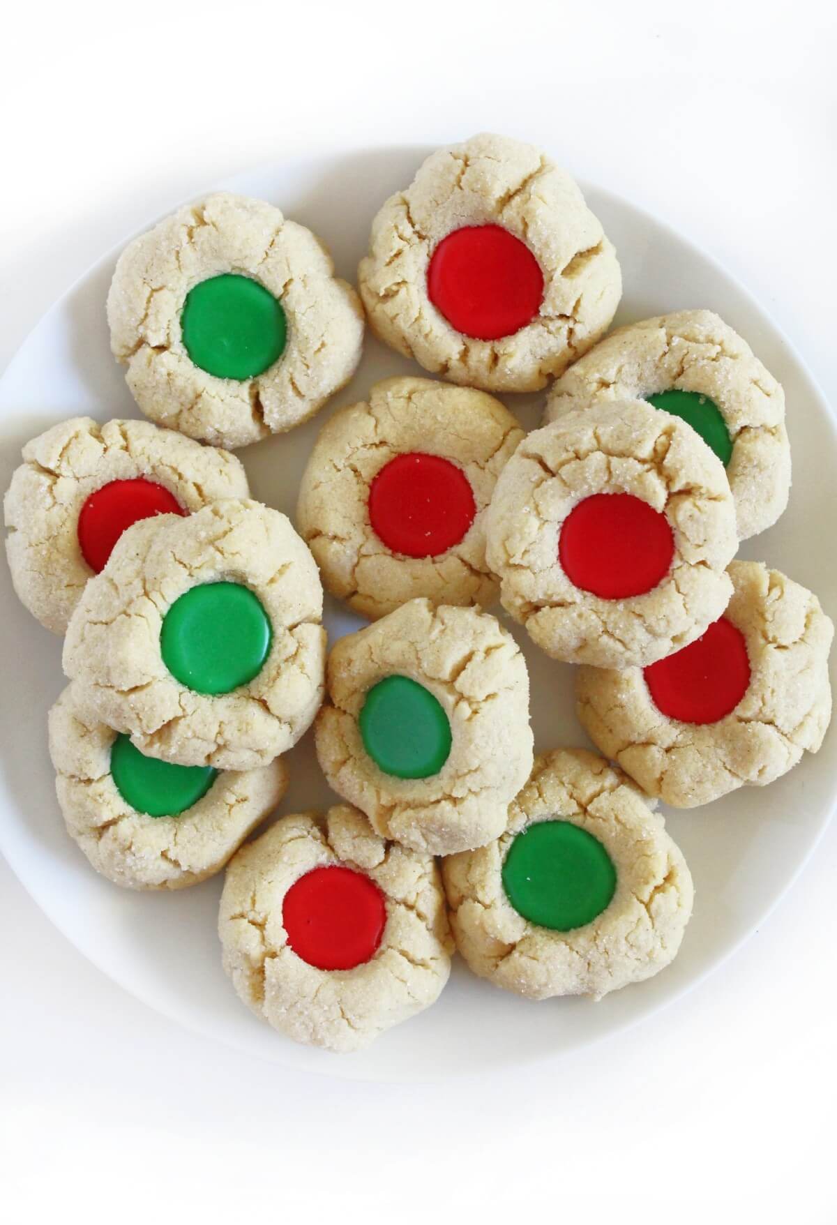 plate of gluten-free thumbprint cookies with red and green icing.