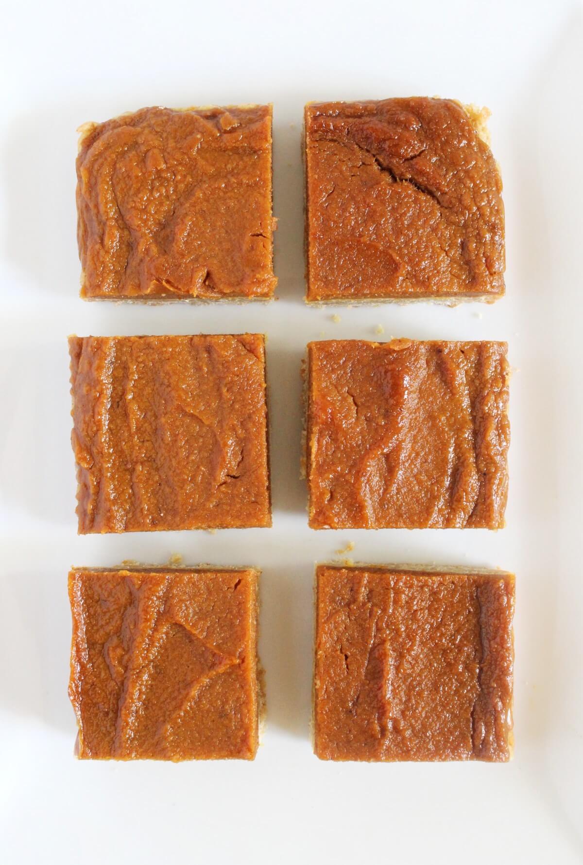 6 cut squares of pumpkin pie bars.