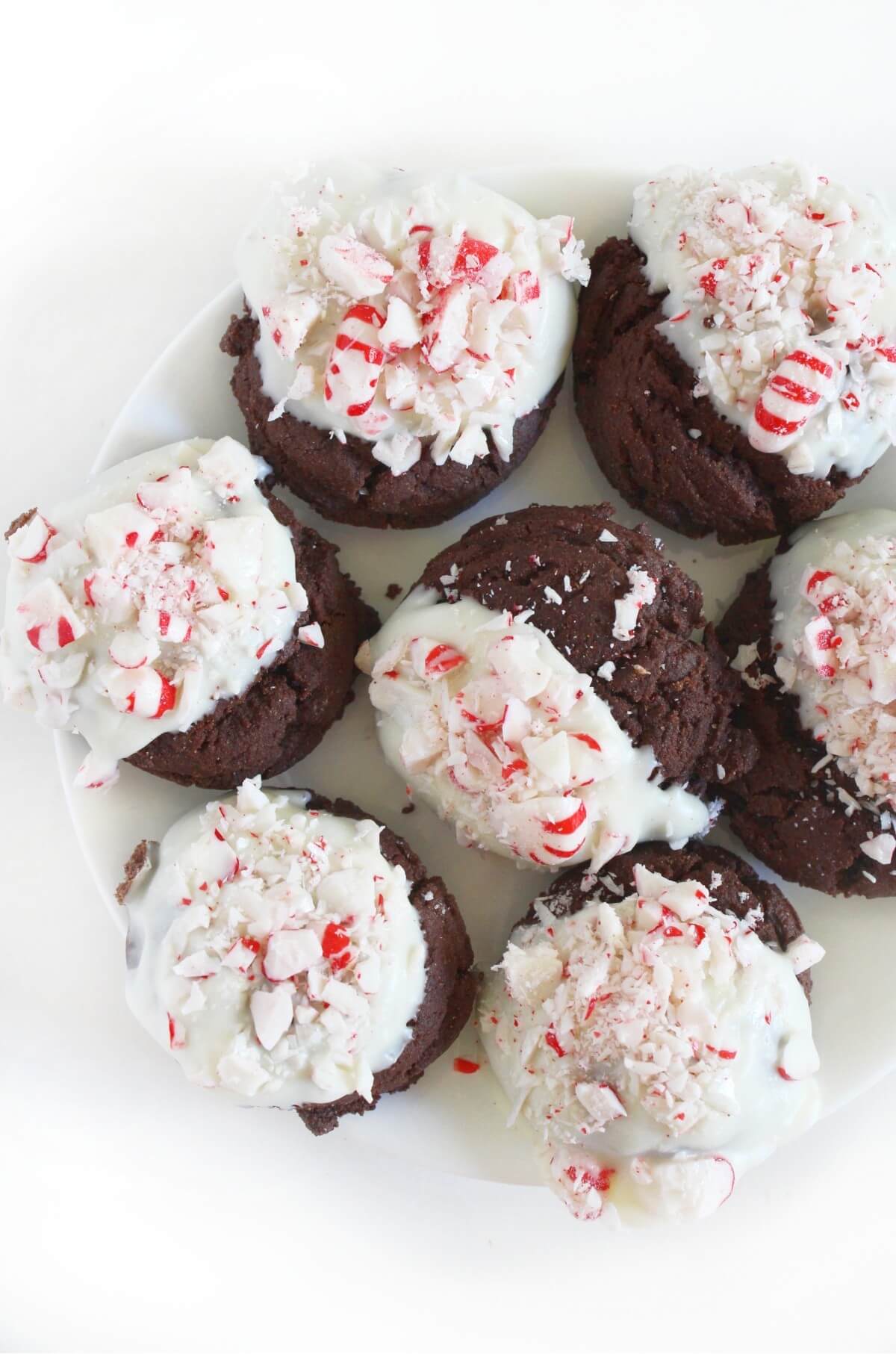 half plate of peppermint bark cookies dipped in vegan white chocolate.