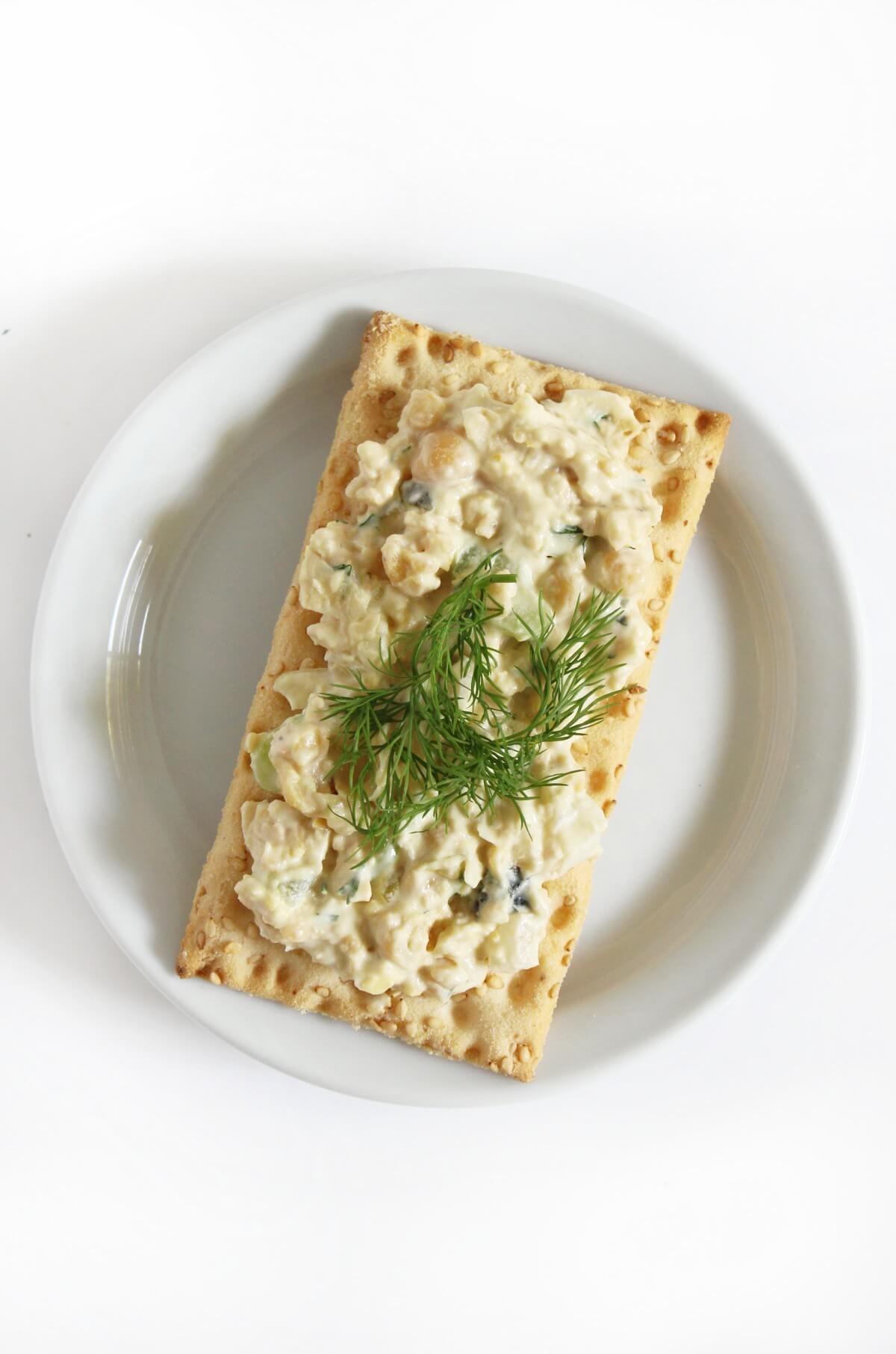 gluten-free cracker with vegan tuna salad and fresh dill.
