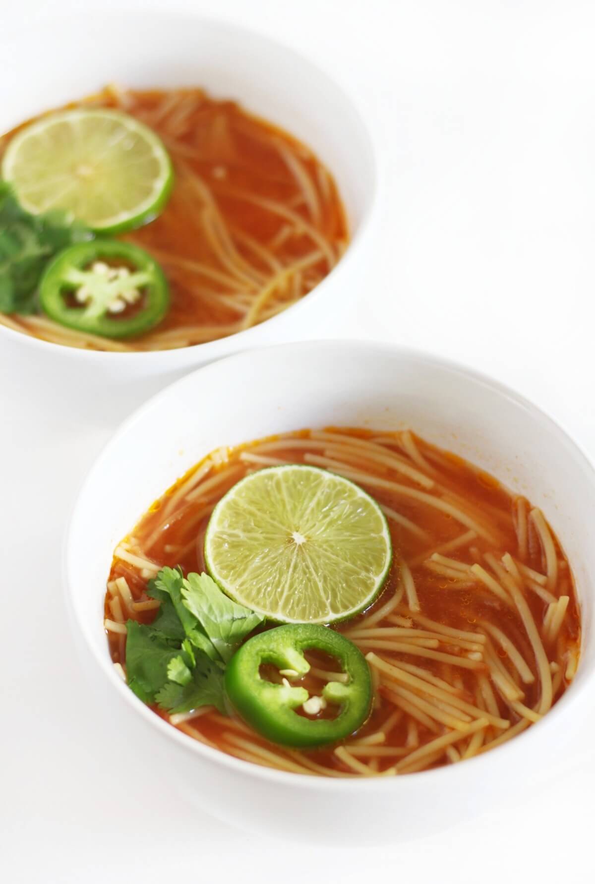 close up of two bowls of easy sopa de fideo.