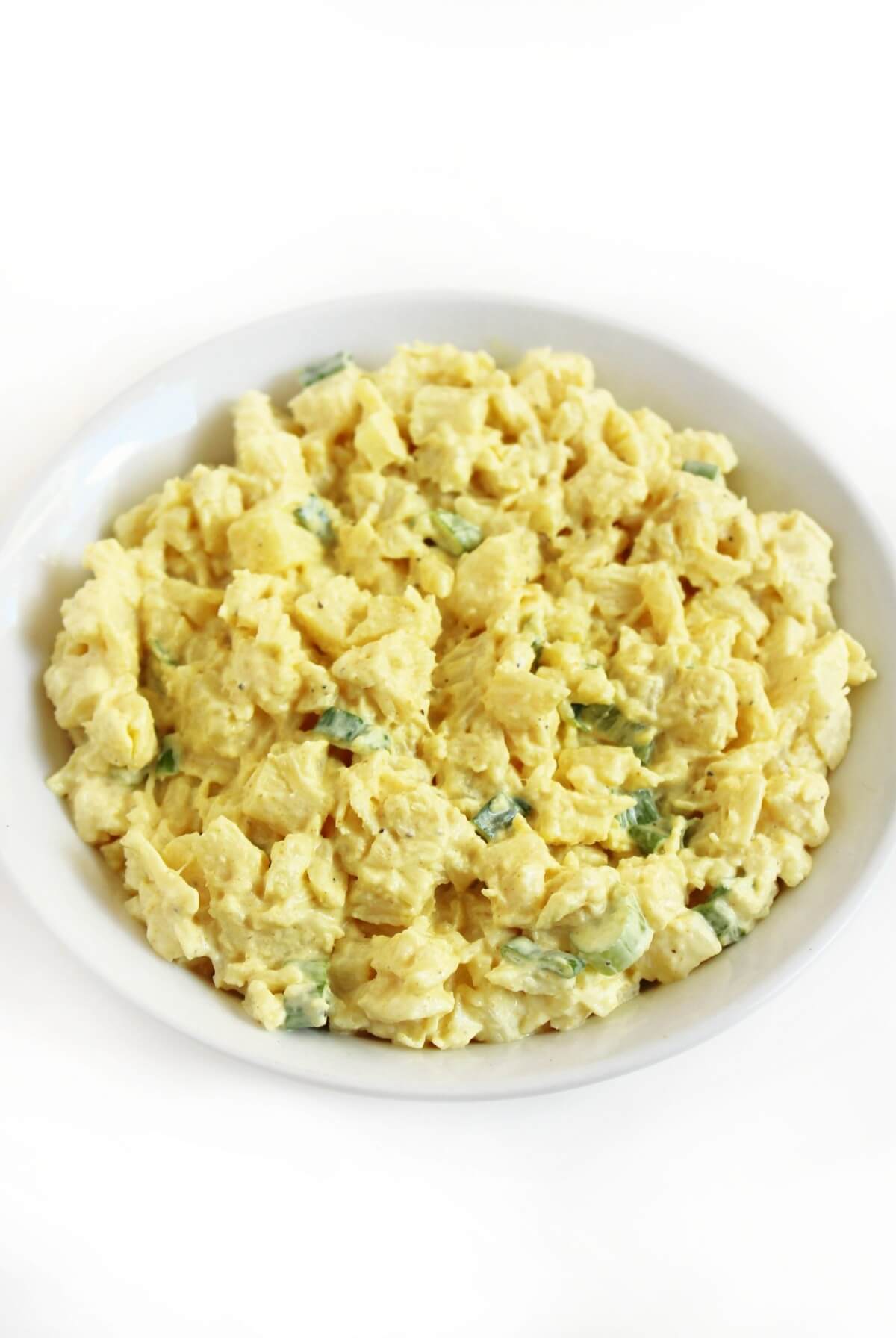 full serving bowl with vegan egg salad made with hearts of palm.