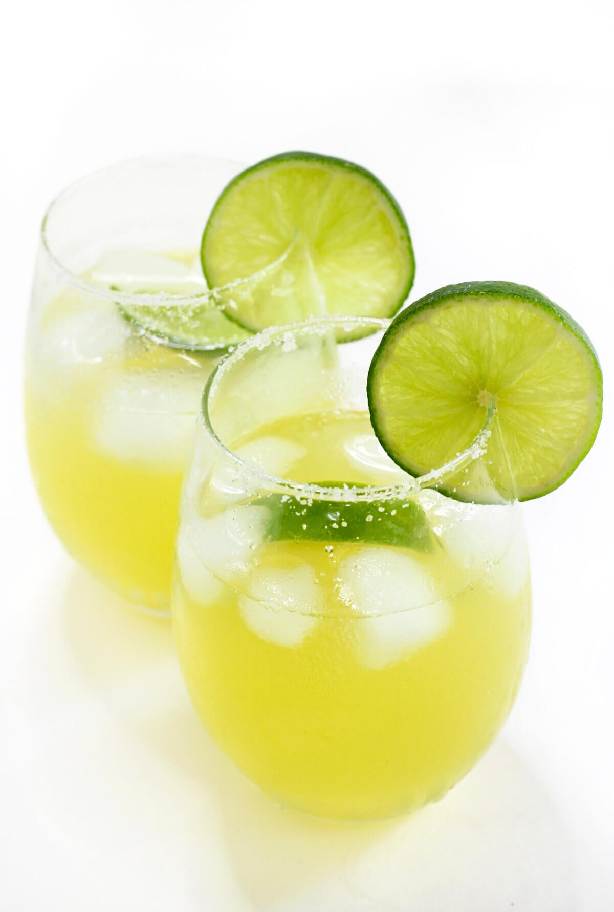 two ready to drink virgin margaritas with salted rims and lime slices.