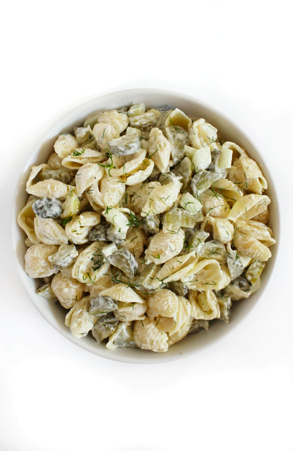 mixed creamy dill pickle pasta salad in bowl.