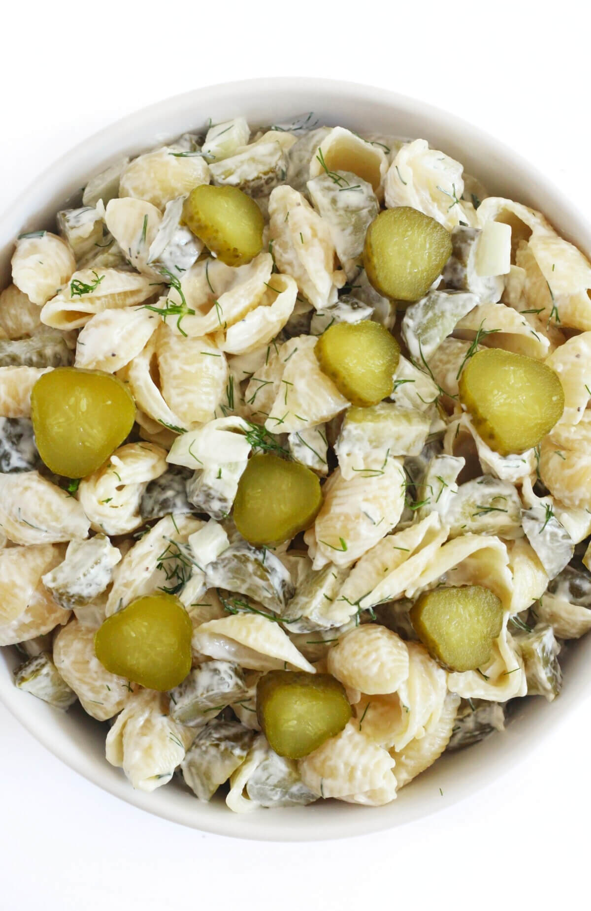 close up of gluten-free pickle pasta salad with extra pickle slices.