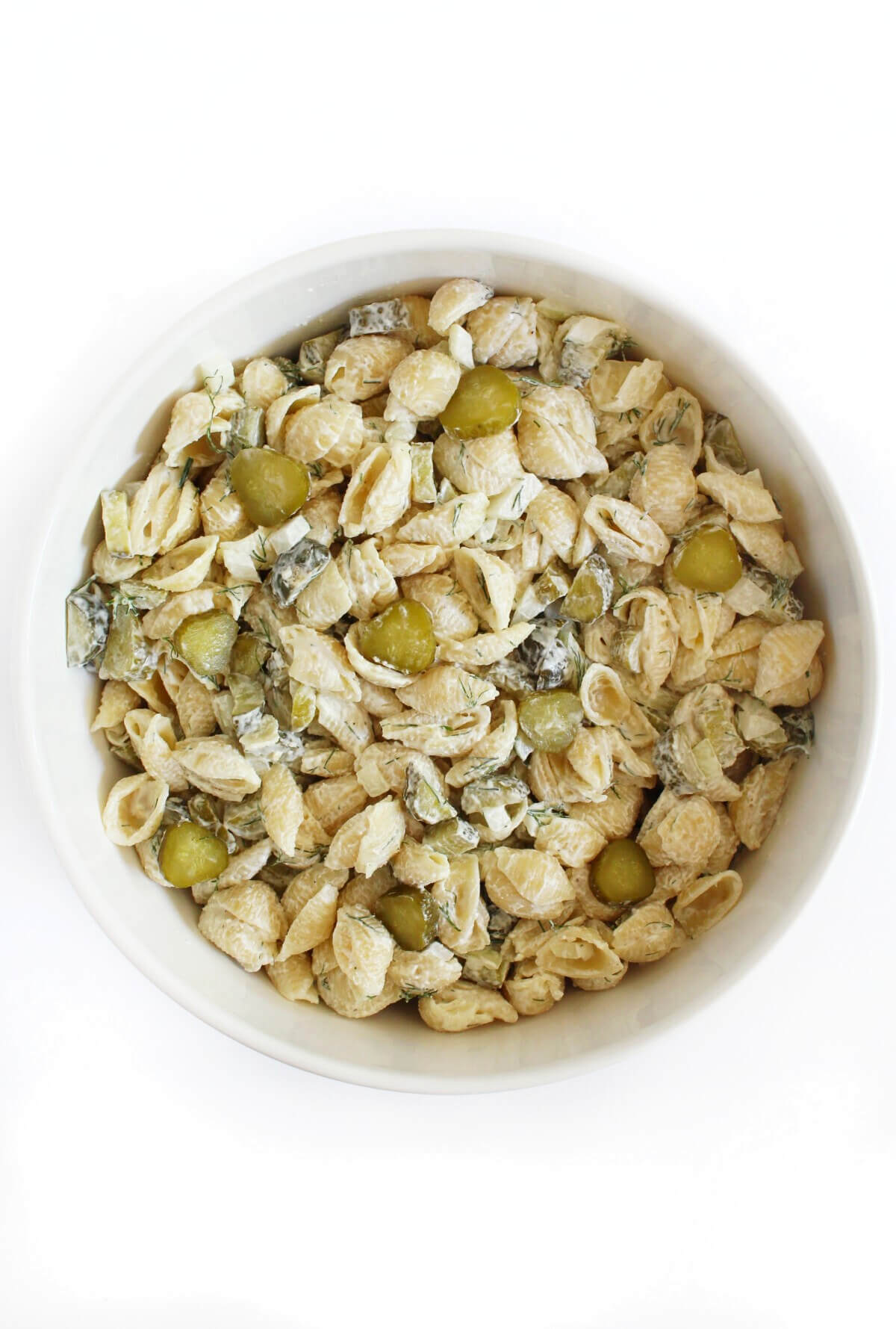 dill pickle pasta salad in large white serving bowl.