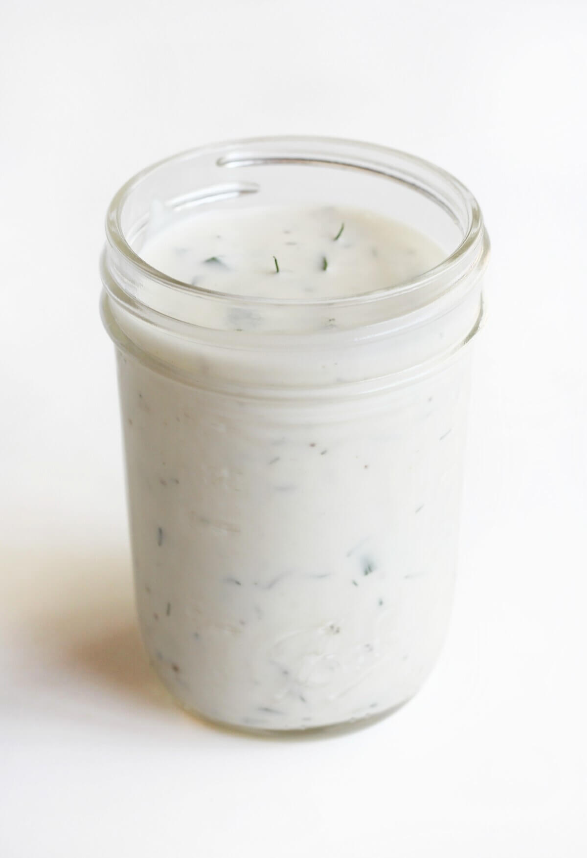 glass jar for storing homemade vegan ranch dressing.