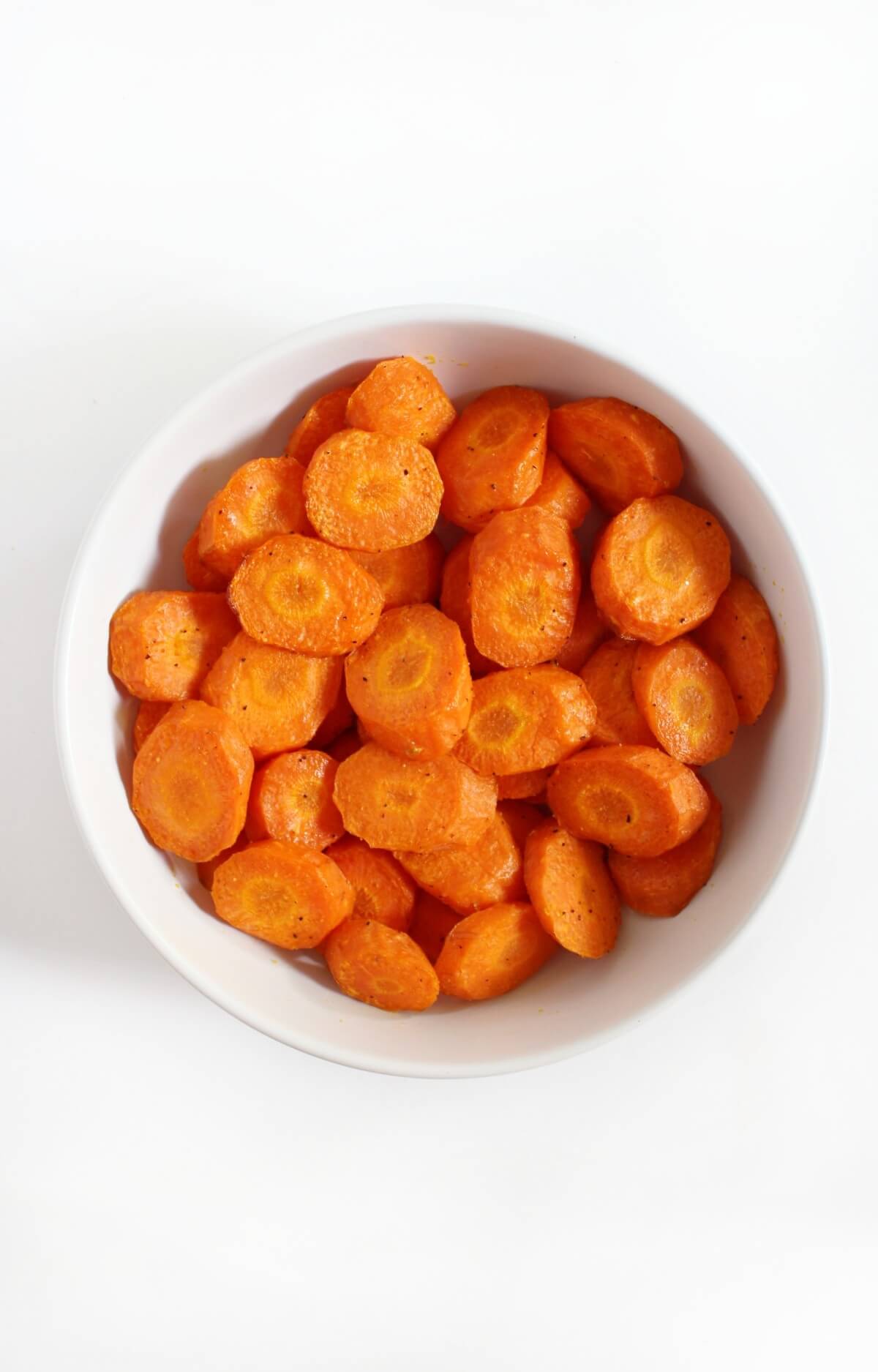 finished air fryer carrots in white bowl to serve.
