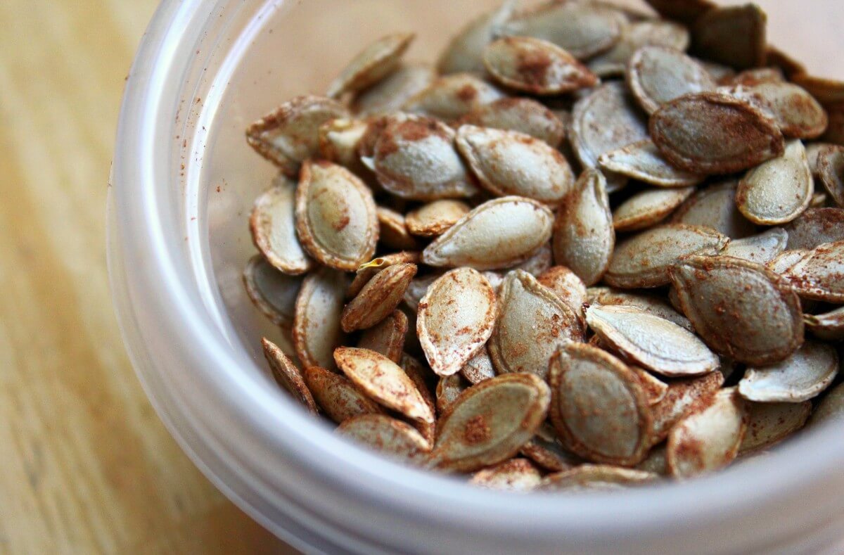 roasted cinnamon butternut squash seeds in small bowl.