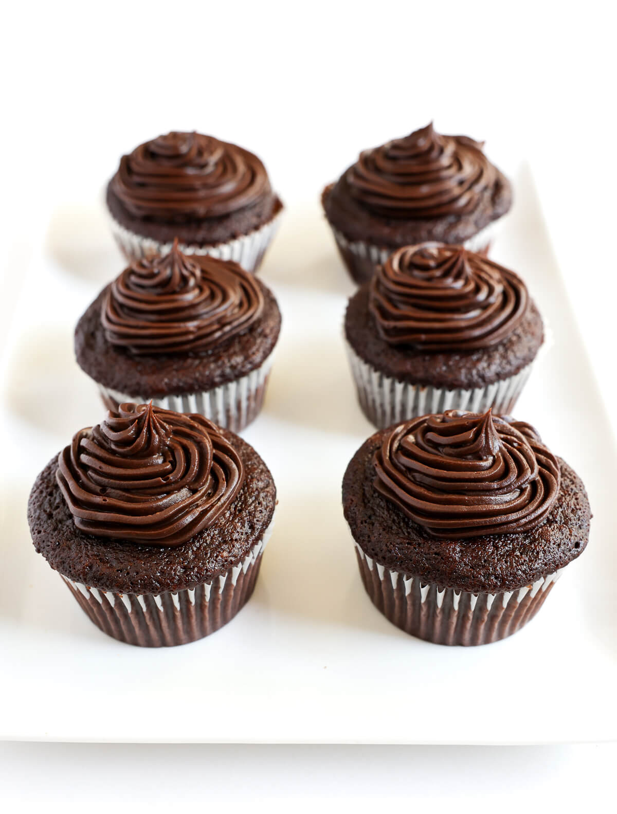 6 frosted gluten-free chocolate cupcakes.