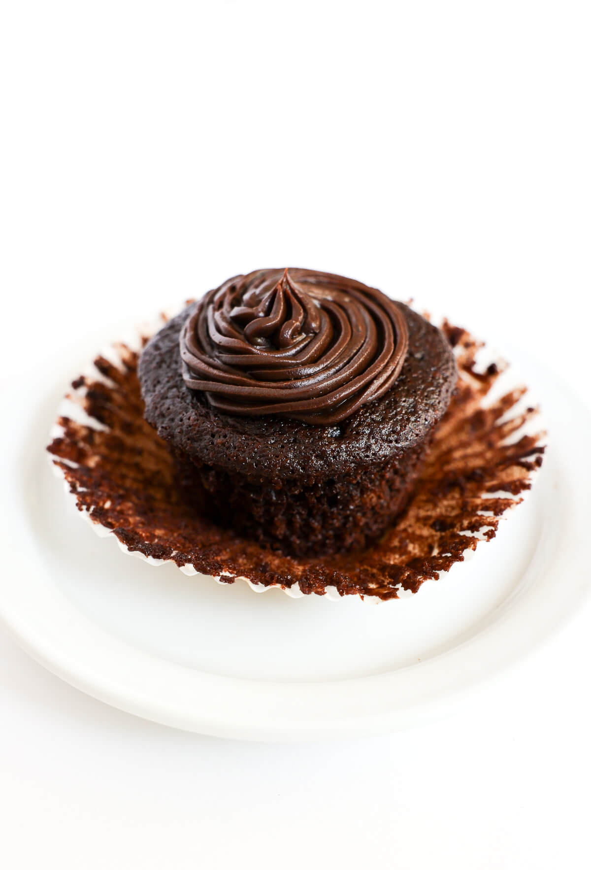 gluten-free chocolate cupcake with wrapper peeled off.