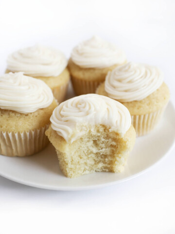 gluten-free vegan vanilla cupcakes on white plate.