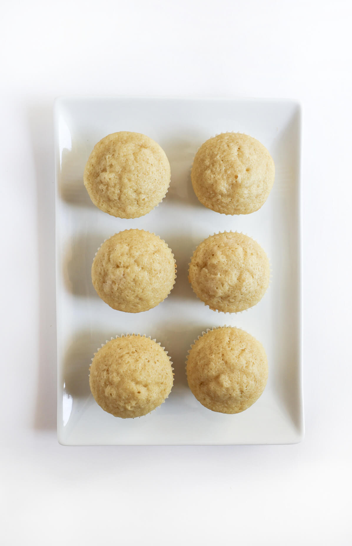 plain unfrosted gluten-free vegan vanilla cupcakes on plate.