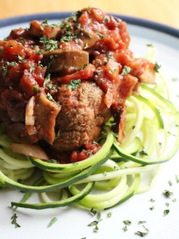 vegan meatballs and zucchini noodles on plate.