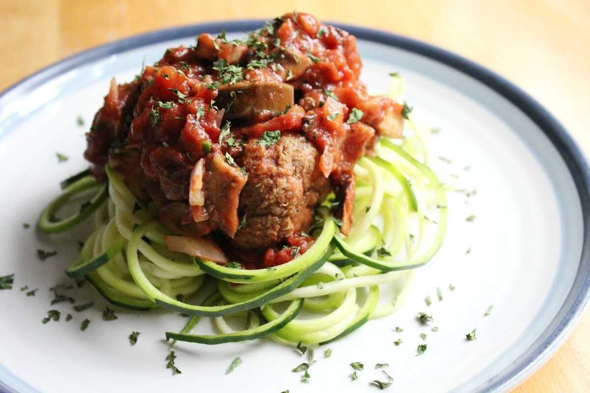 vegan meatballs and zucchini noodles on plate.