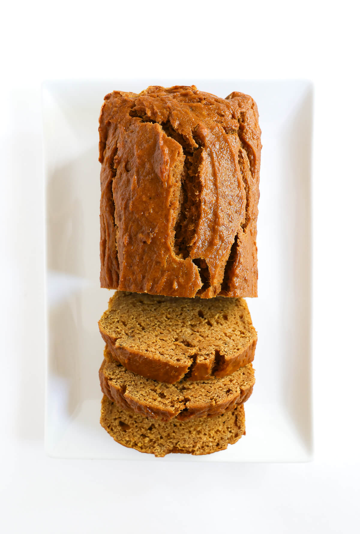 overhead loaf of gluten-free pumpkin banana bread with 3 slices.
