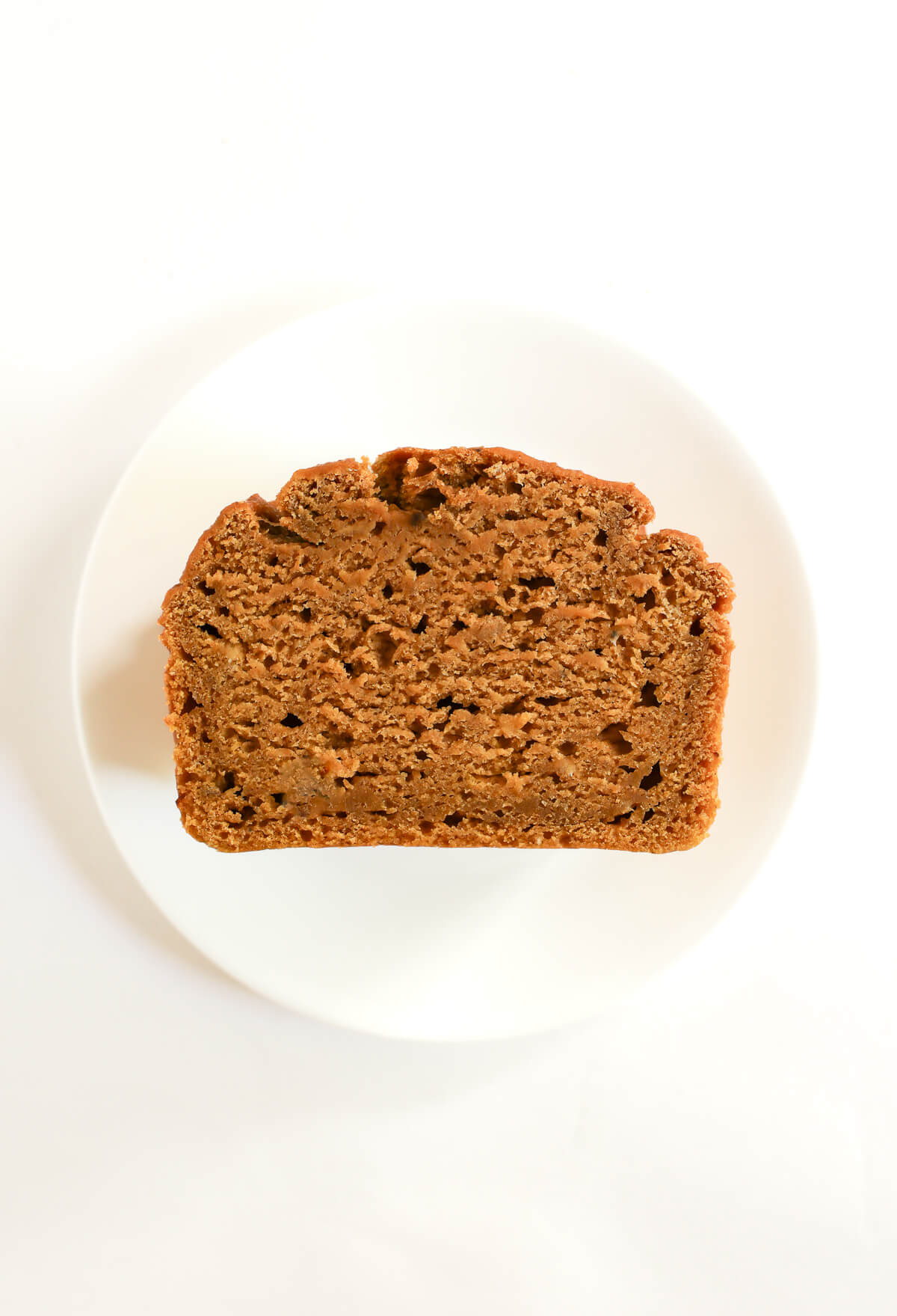 one slice of pumpkin banana bread showing perfect crumb.