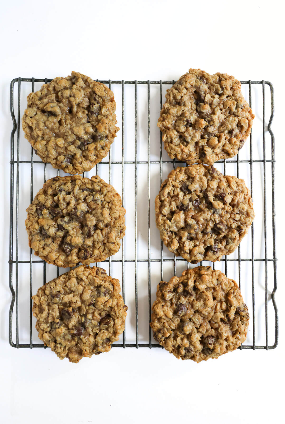 cooling baked vegan oatmeal cookies on wire rack.