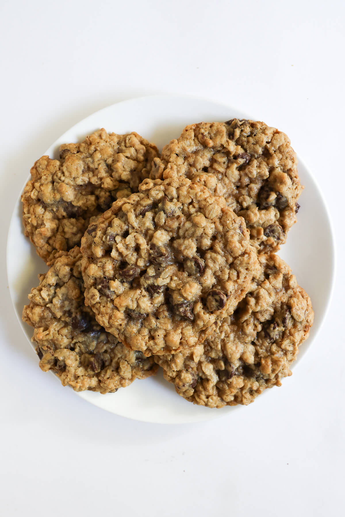 plate with 4 gluten-free vegan oatmeal chocolate chip cookies.