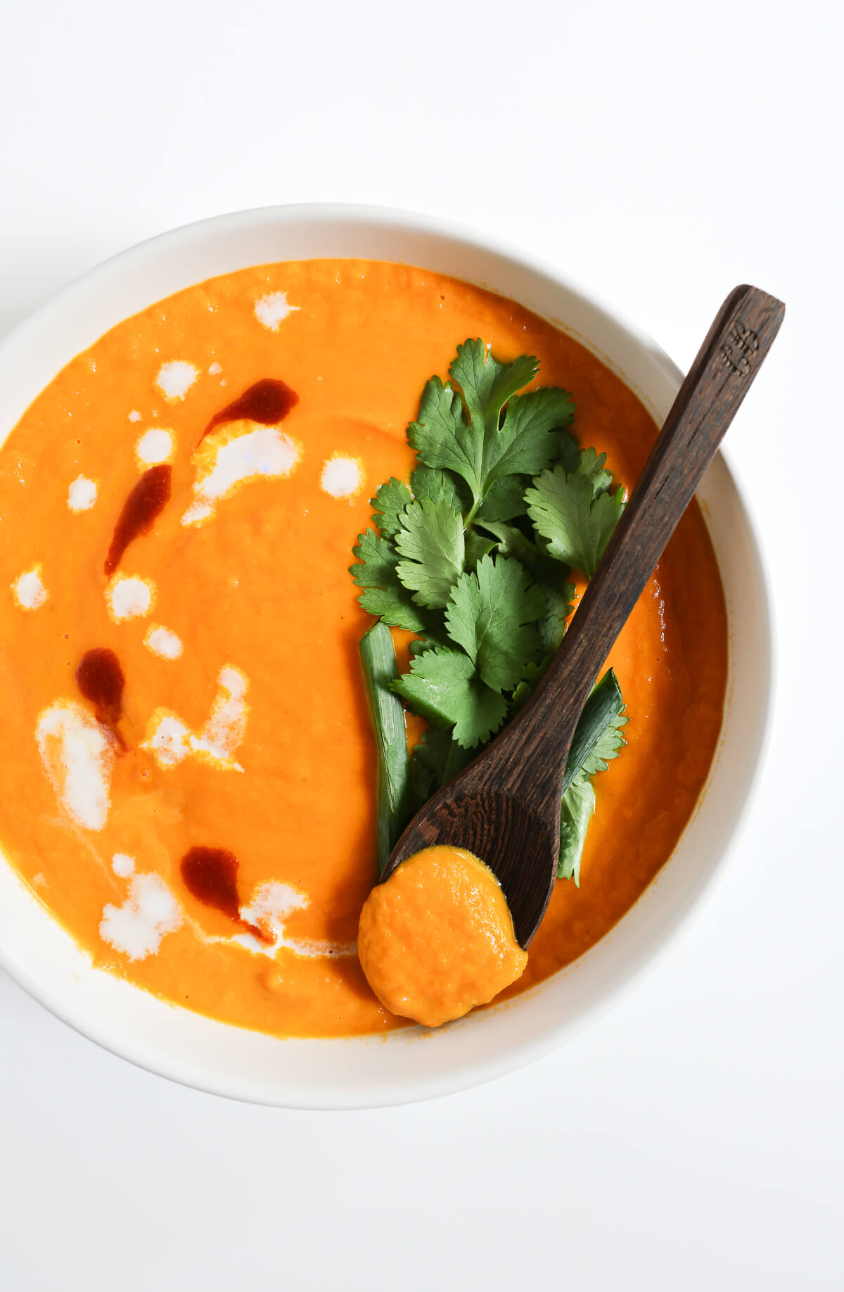 side of thai carrot soup with extra cilantro and scallions on top.